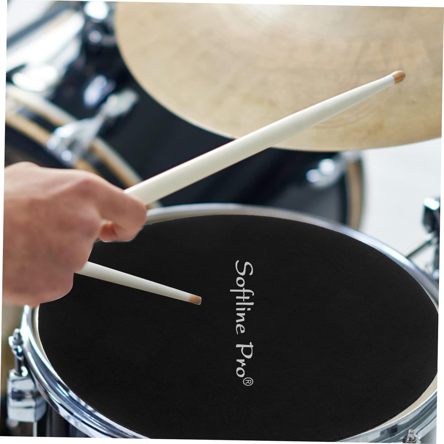 Drum set with a hand holding drumsticks on a black drumhead, branded 'Sofline Pro'.