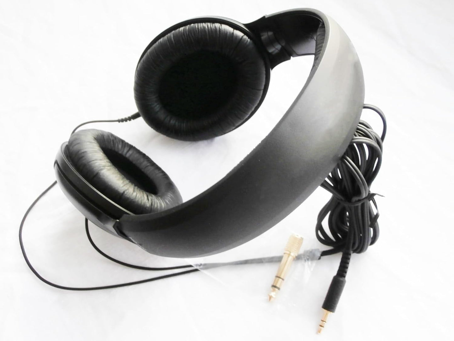 Black headphones with a cable on a white background