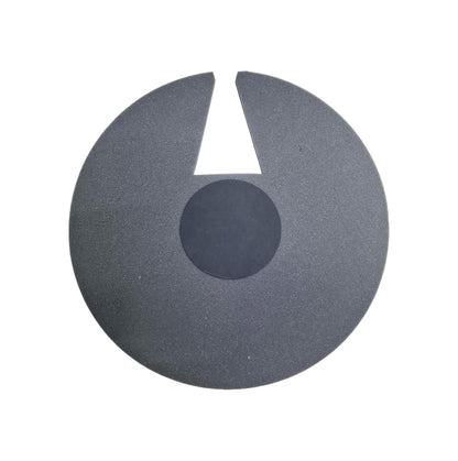 Black circular object with a central cutout on a white background