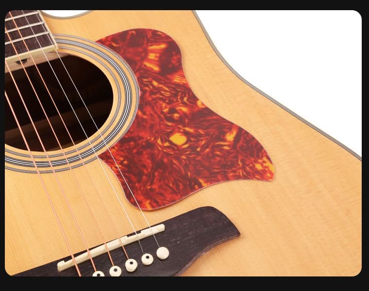 Close-up of an acoustic guitar's soundhole and bridge on a white background