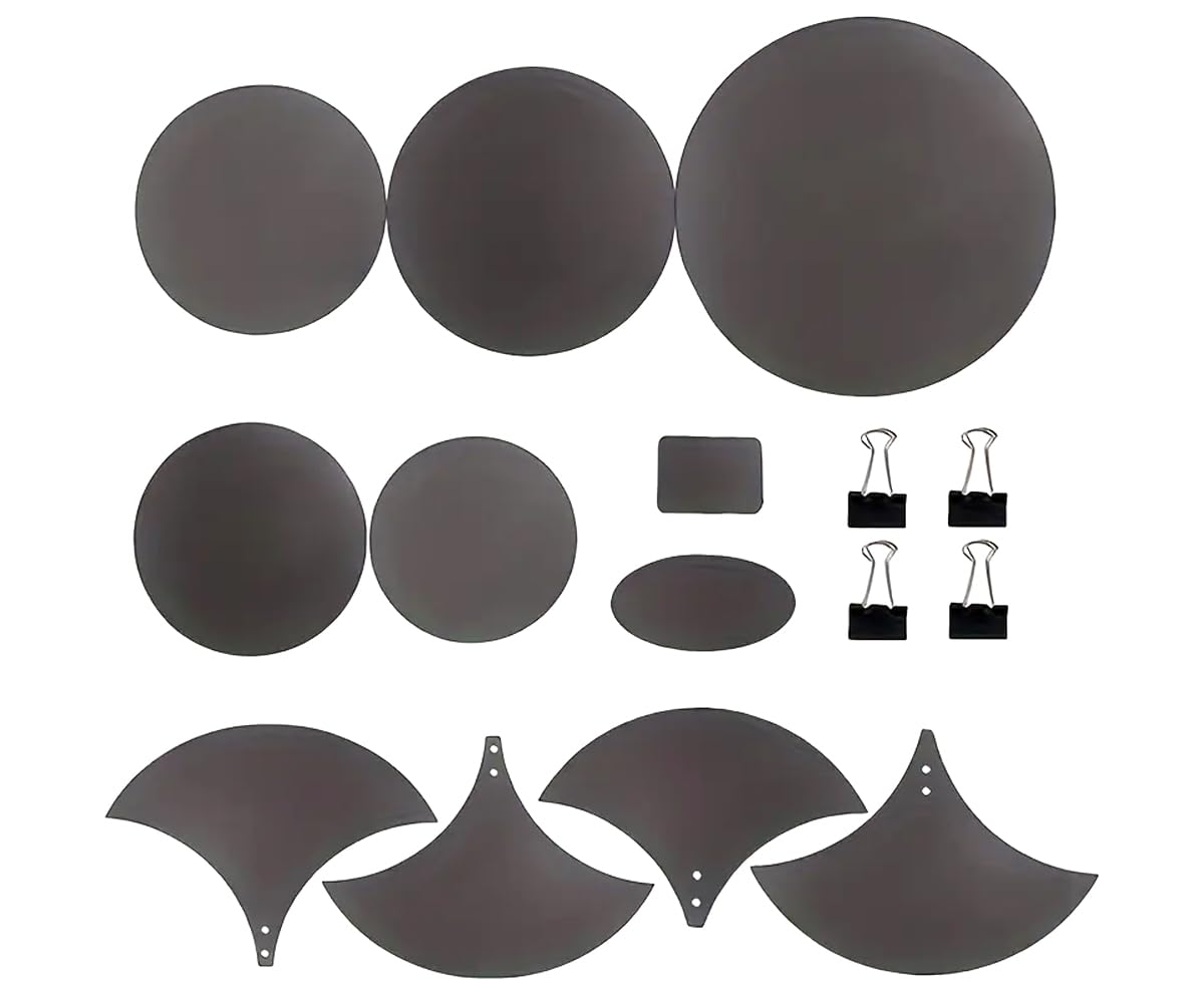 Set of black adhesive pads and clips on a white background