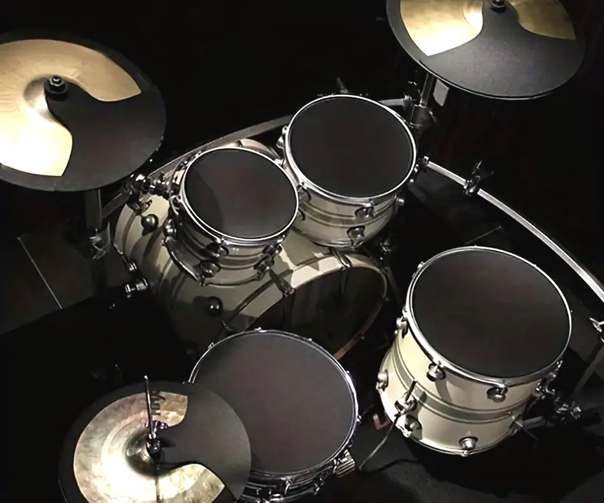 Top-down view of a drum set with various drums and cymbals on a black background