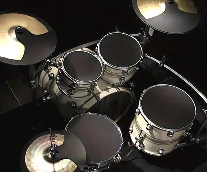 Top-down view of a drum set with various drums and cymbals on a black background