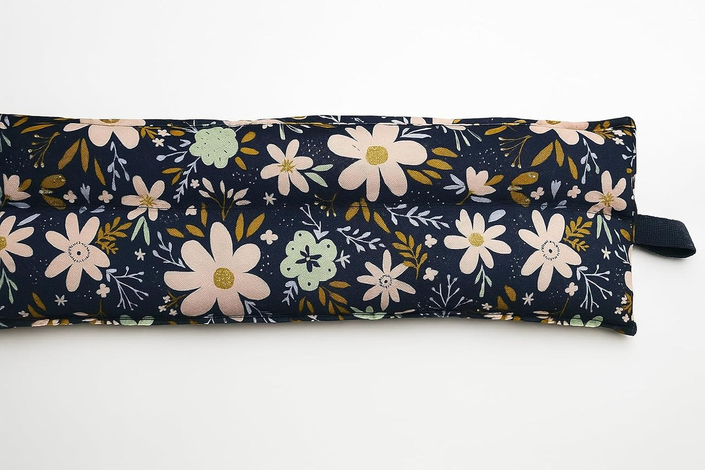 Floral-patterned fabric roll on a white background