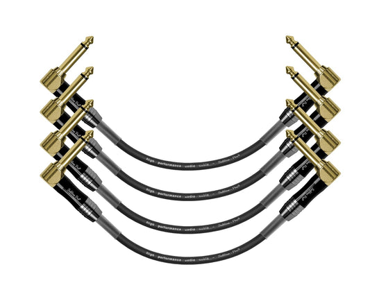 Four guitar cables with gold connectors on a white background