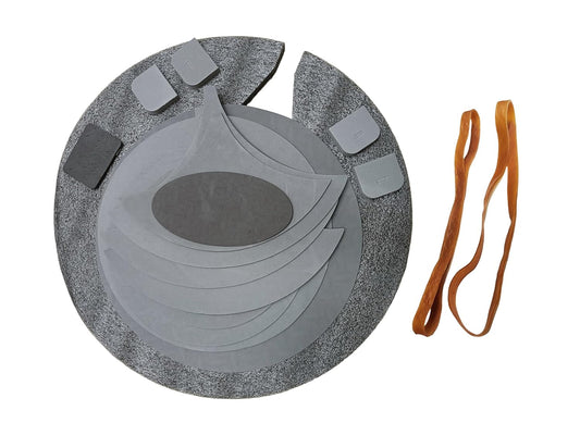 Gray circular object with textured surface and orange strap on a white background