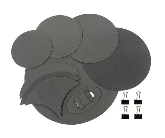 Set of gray circular and oval-shaped adhesive pads with clips on a white background