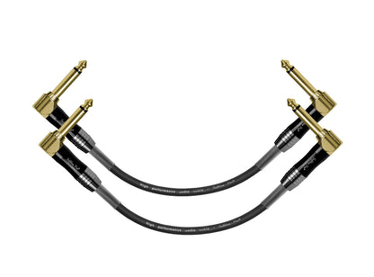 Black guitar cable with gold connectors on a white background