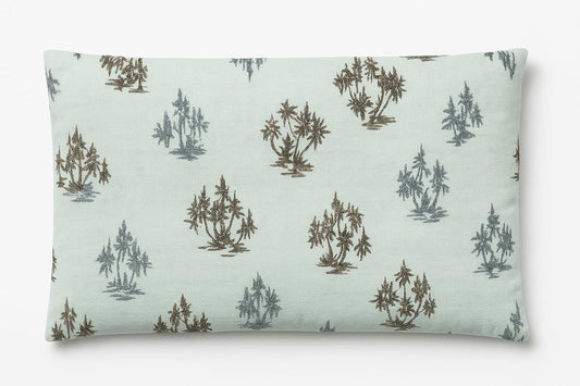 Rectangular pillow with tree pattern on a light green background