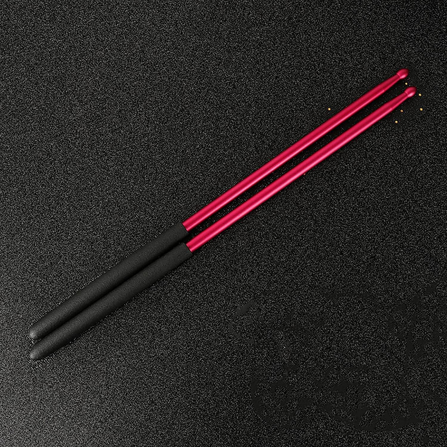 Black and pink drumsticks on a black background