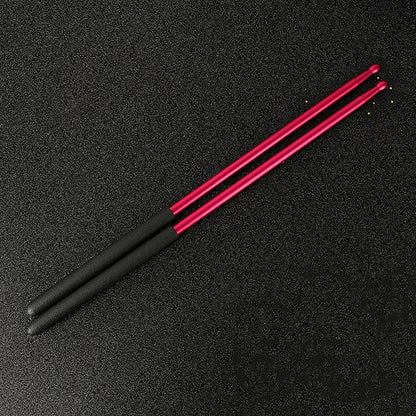Black and pink drumsticks on a black background