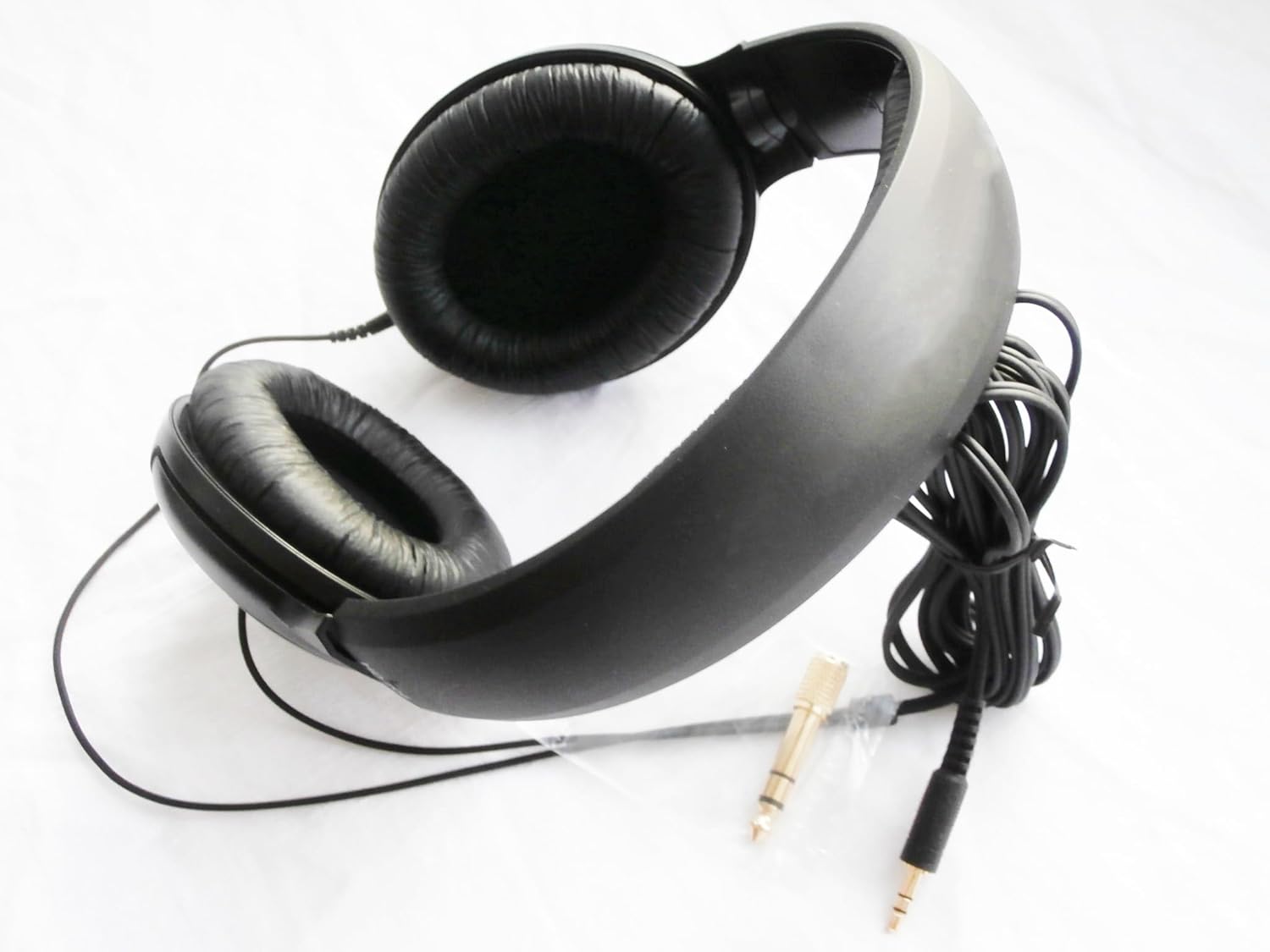 Black headphones with a cable on a white background