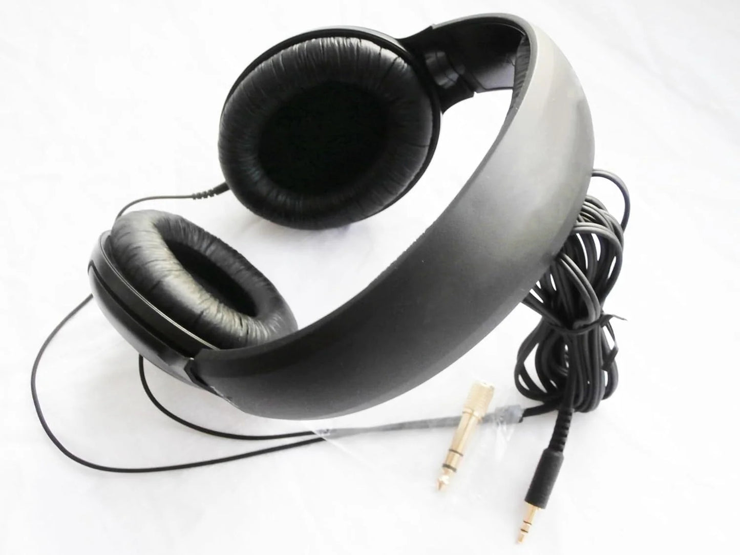 Black headphones with a cable on a white background