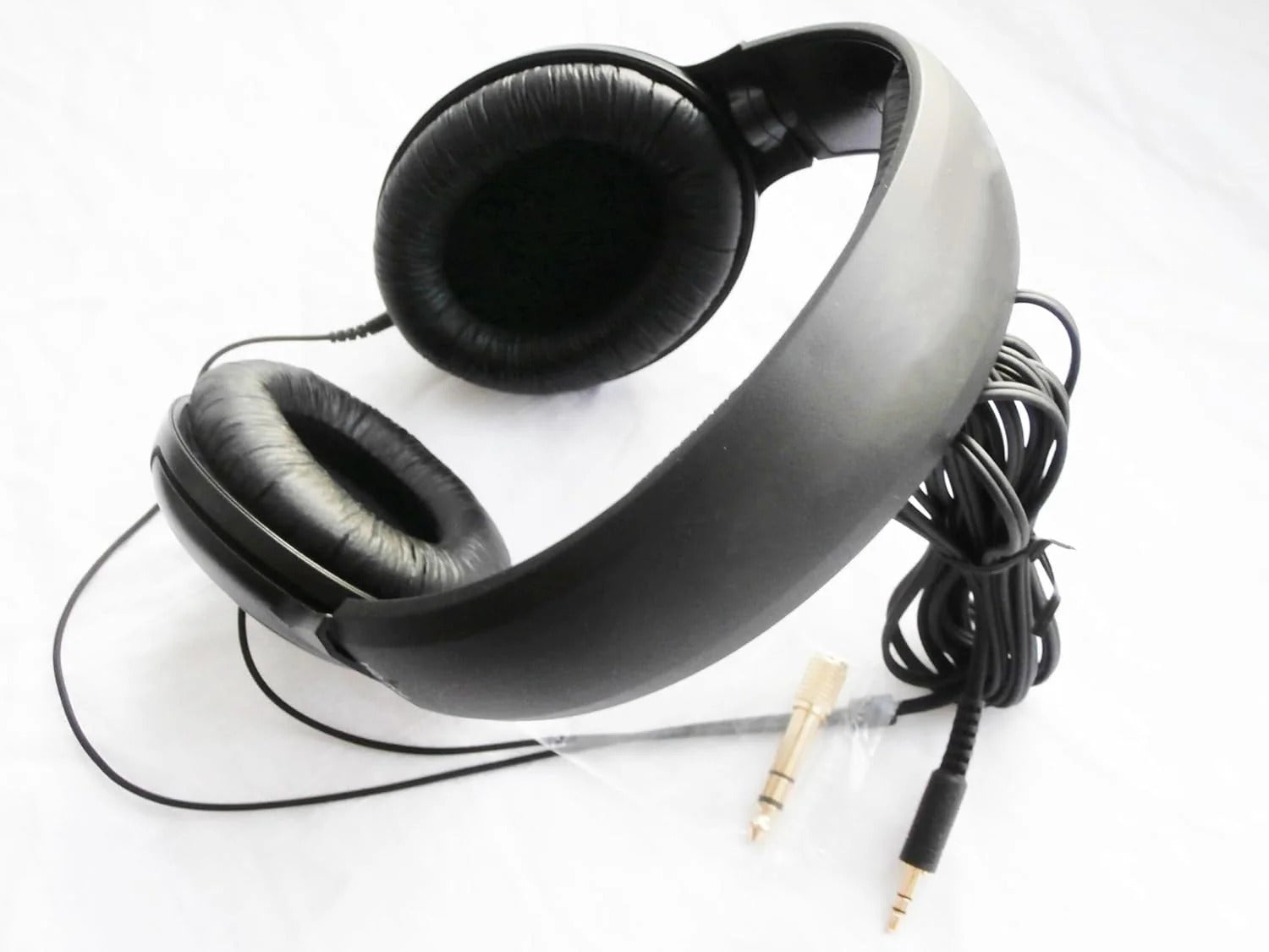 Black headphones with a cable on a white background
